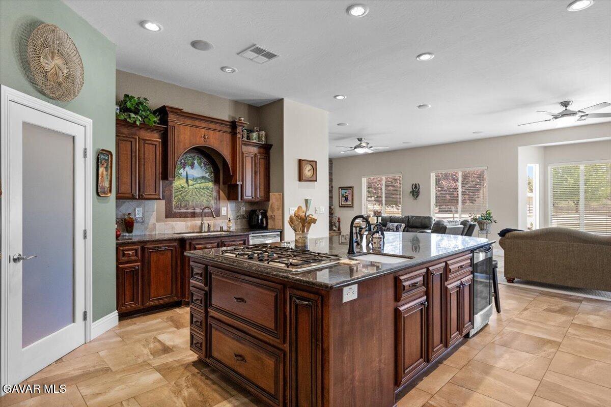 23840 Martingale Way Tehachapi, CA 93561 - Photo 15 of 63 a kitchen with stainless steel appliances granite countertop a stove and a sink