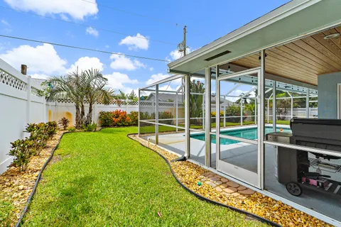 a view of a house with a backyard and a patio