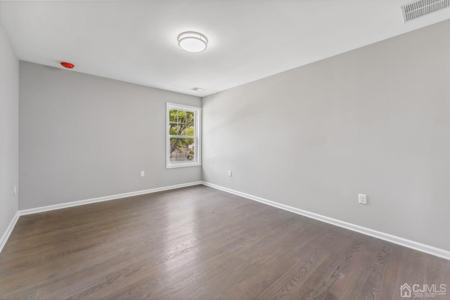 17 Matson Road Edison, NJ 08817 - Photo 13 of 20 a view of an empty room with wooden floor and a window