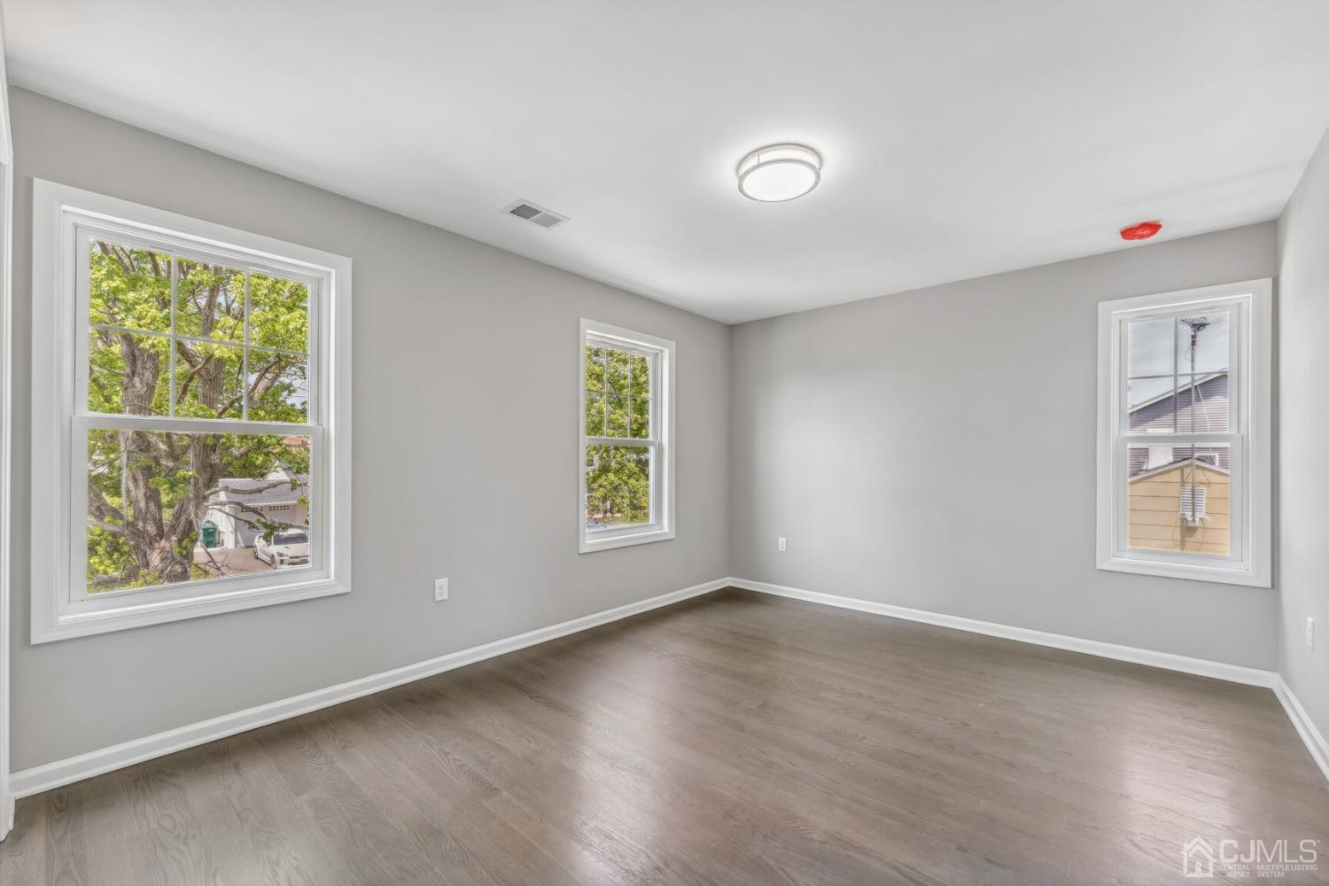 17 Matson Road Edison, NJ 08817 - Photo 14 of 20 a view of an empty room with a window and wooden floor