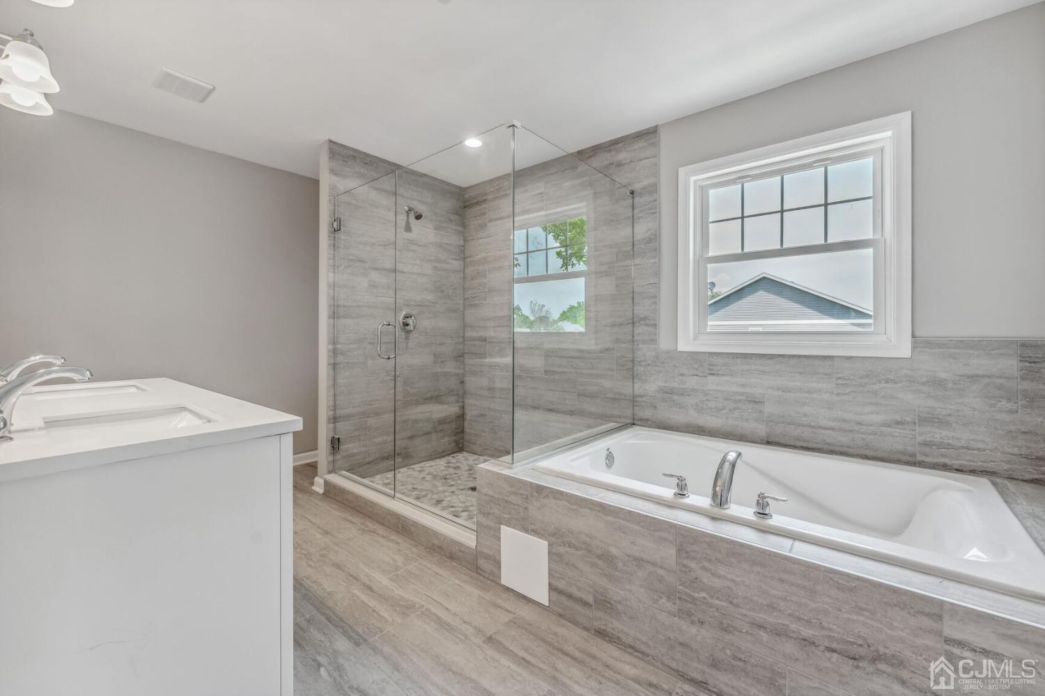 17 Matson Road Edison, NJ 08817 - Photo 17 of 20 a bathroom with a tub a sink and a window
