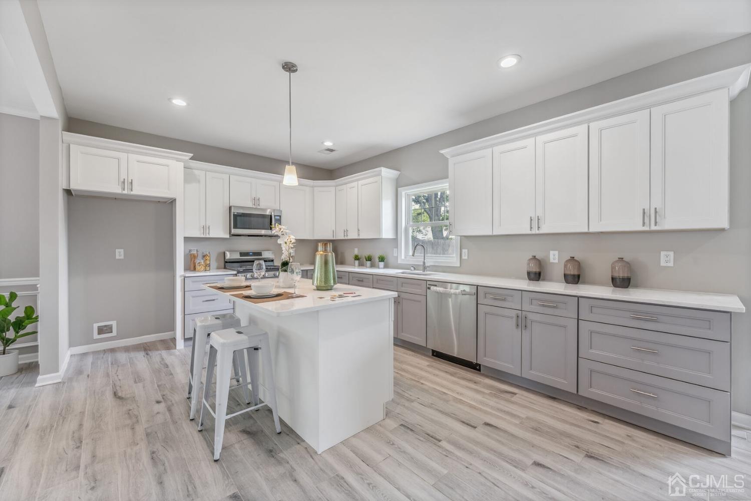 17 Matson Road Edison, NJ 08817 - Photo 6 of 20 a kitchen with a sink a center island cabinets and a window