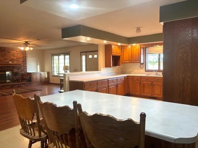a large white kitchen with a large window