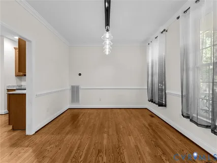 an entryway view with wooden floor and staircase