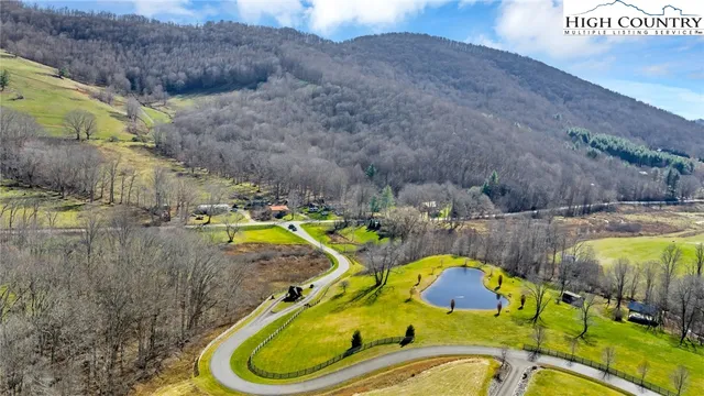 a view of a dry yard with mountains in the background