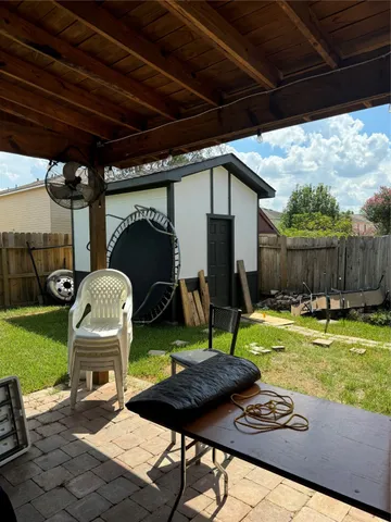 a backyard of a house with table and chairs