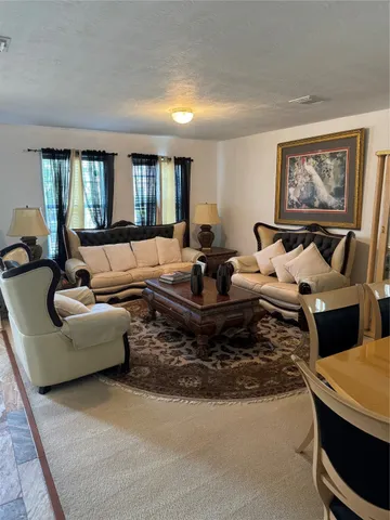 a living room with furniture fireplace and a window