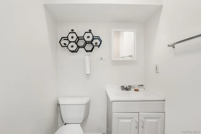 a bathroom with a sink and mirror with toilet