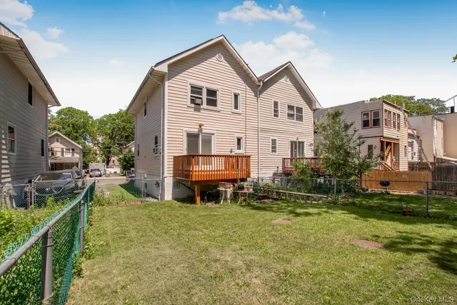 a view of house with yard and sitting area
