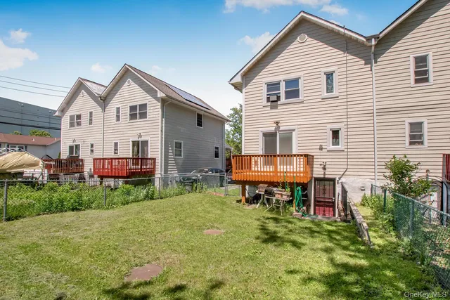a view of a house with a yard and furniture