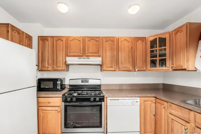 a kitchen with a stove a sink and a cabinets