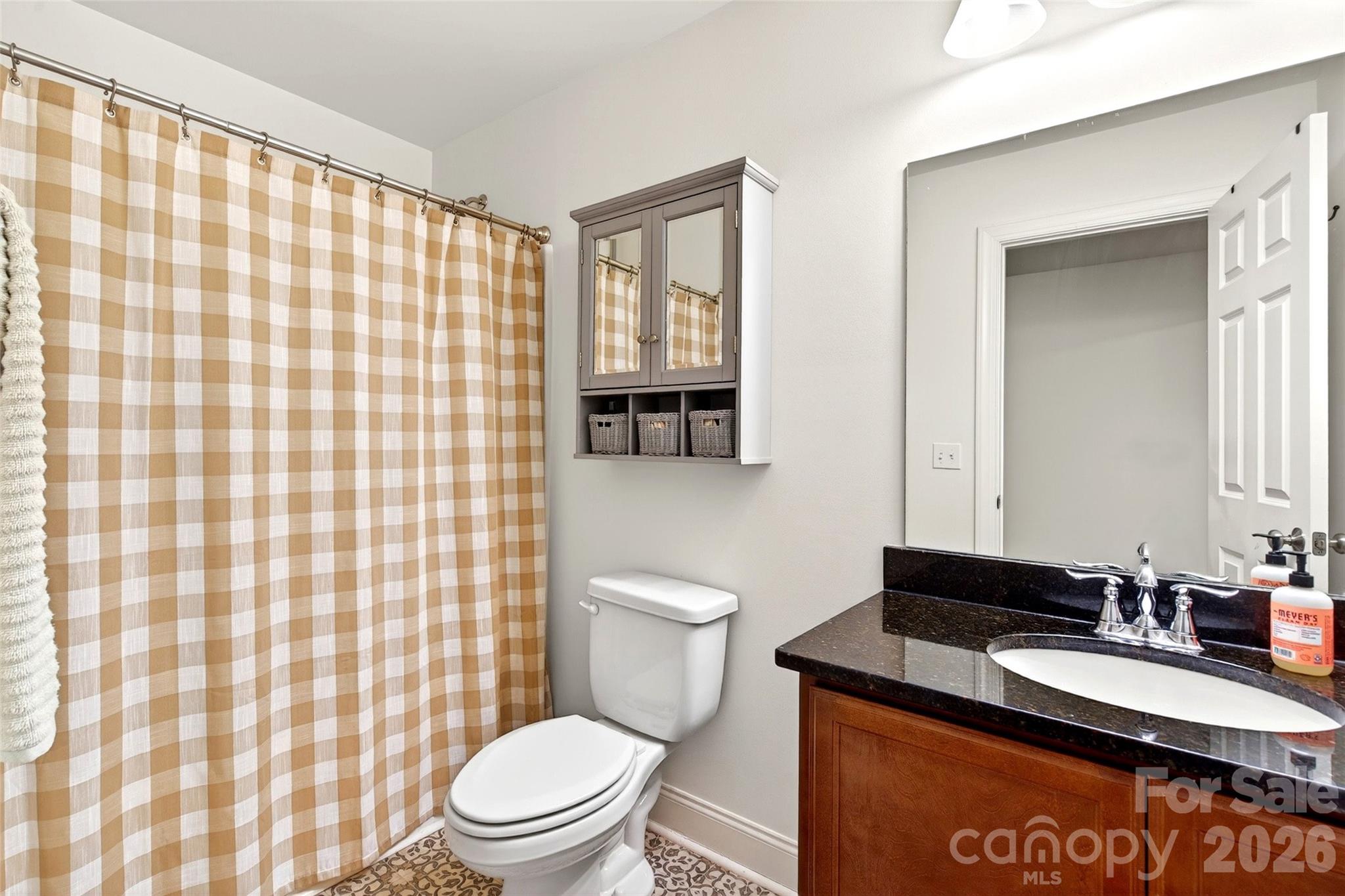 132 Maple Ridge Drive Old Fort, NC 28762 - Photo 33 of 40 a bathroom with a granite countertop toilet sink and mirror