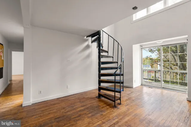 a view of wooden floor and windows in a room