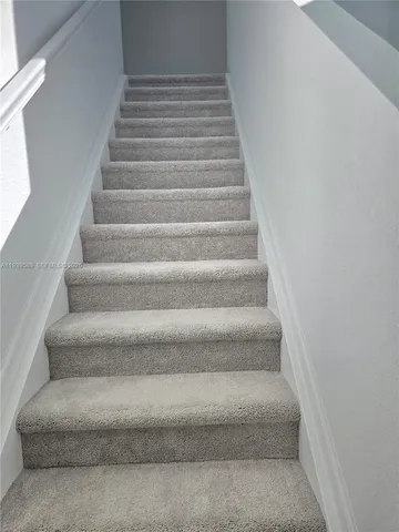 a view of staircase with white walls