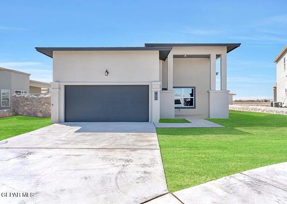 a front view of a house with a yard and garage