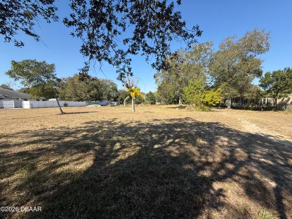 an aerial view of a house with a backyard