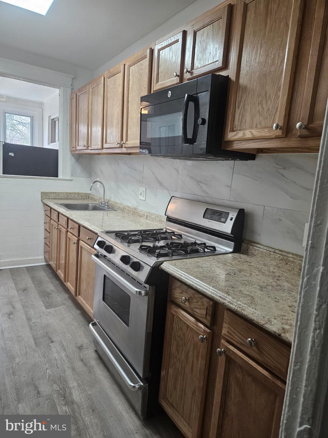 5319 3rd Street Northwest Washington, DC 20011 - Photo 7 of 15 a kitchen with stainless steel appliances granite countertop a stove a sink and a microwave