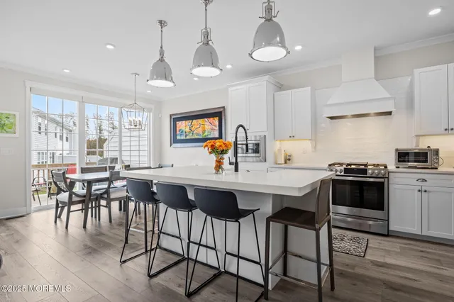 a kitchen with stainless steel appliances a sink stove and refrigerator