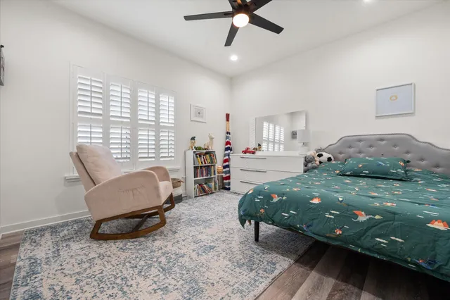 a bedroom with a bed a couch and a window