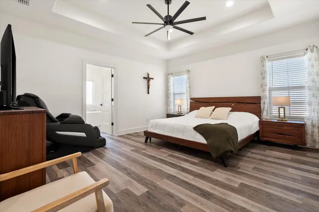 a bedroom with a bed and a flat screen tv