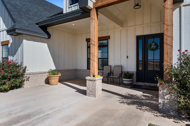 a view of a patio with table and chairs potted plants