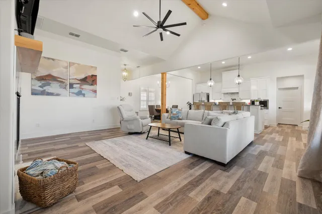a living room with furniture and kitchen view