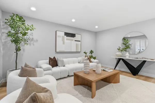 a living room with furniture and a potted plant