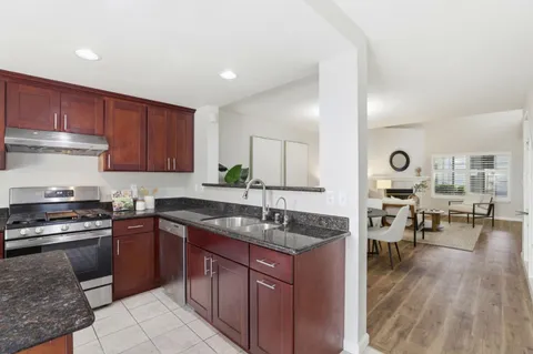 a kitchen with a sink stove and cabinets