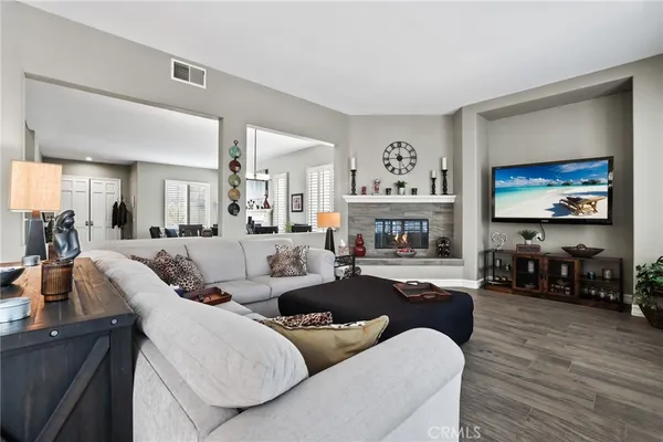 a living room with furniture large window and a fireplace