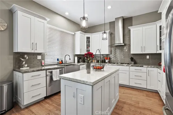 a dining room with stainless steel appliances a table and chairs