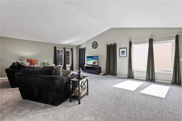 a bedroom with furniture and a flat screen tv