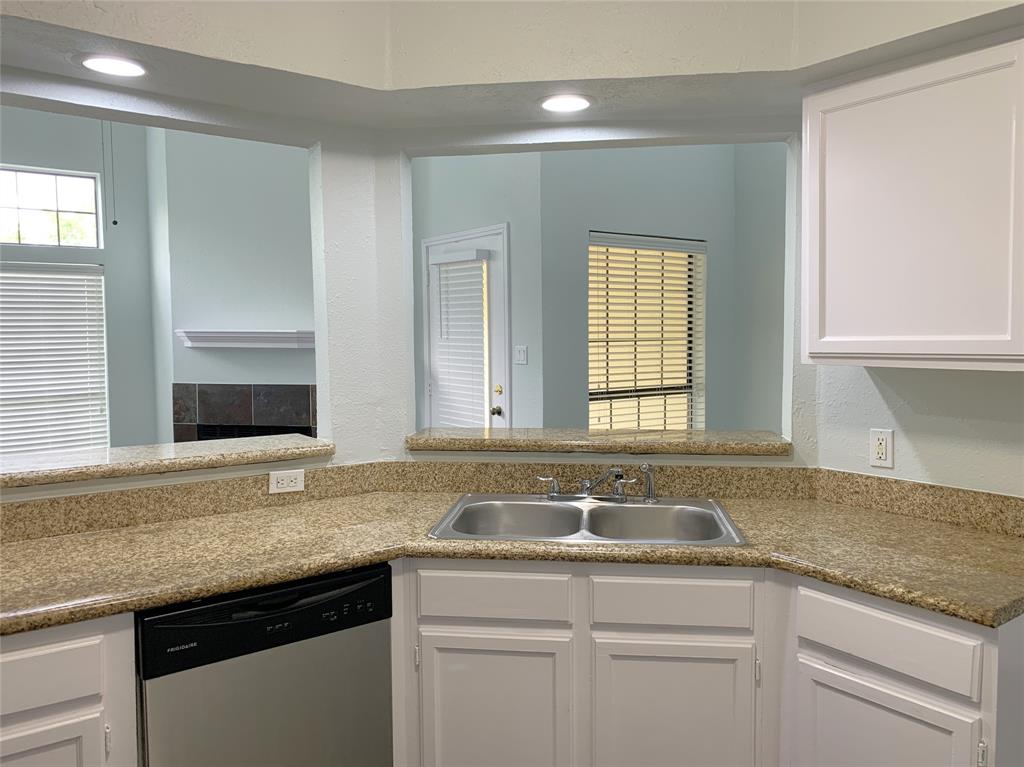 9601 Forest Lane, Unit 1024 Dallas, TX 75243 - Photo 12 of 28 a kitchen with granite countertop a sink and a white wooden cabinets