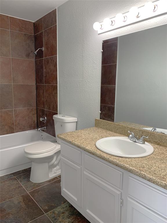 9601 Forest Lane, Unit 1024 Dallas, TX 75243 - Photo 13 of 28 a bathroom with a granite countertop sink mirror vanity and toilet