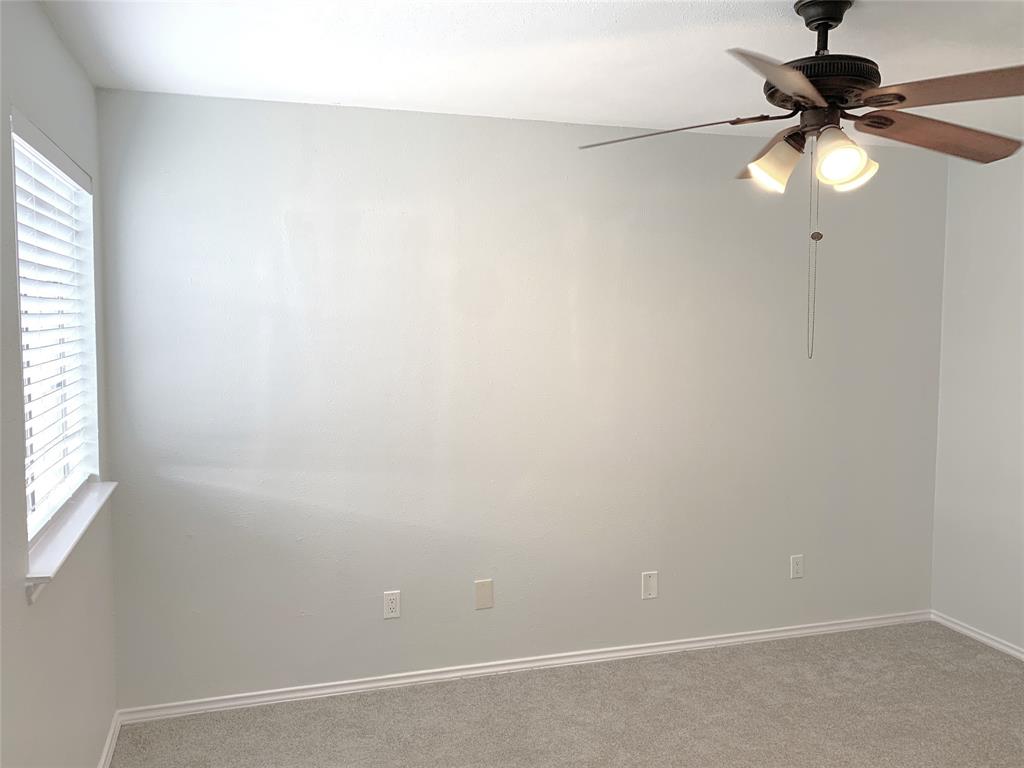 9601 Forest Lane, Unit 1024 Dallas, TX 75243 - Photo 21 of 28 an empty room with a window and a fan