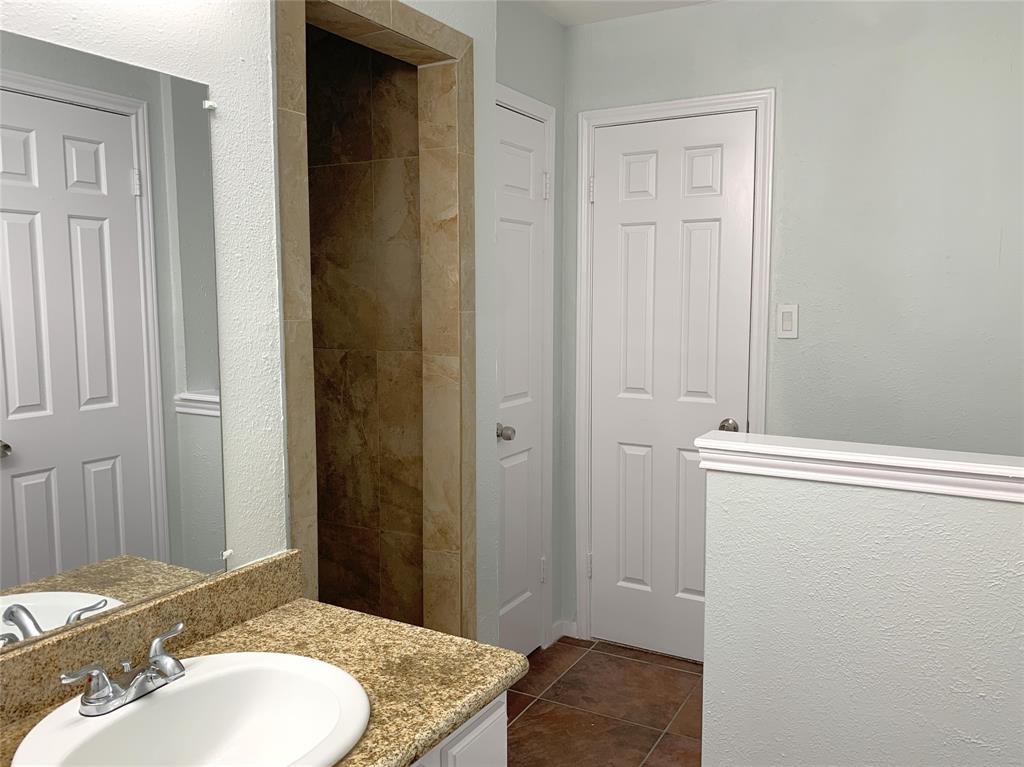 9601 Forest Lane, Unit 1024 Dallas, TX 75243 - Photo 23 of 28 a bathroom with a sink and a mirror