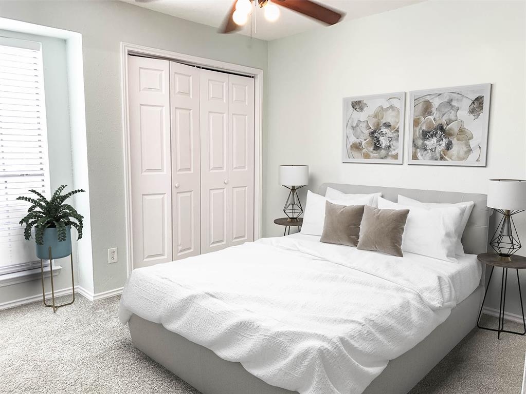 9601 Forest Lane, Unit 1024 Dallas, TX 75243 - Photo 4 of 28 a bedroom with a large bed and a chandelier