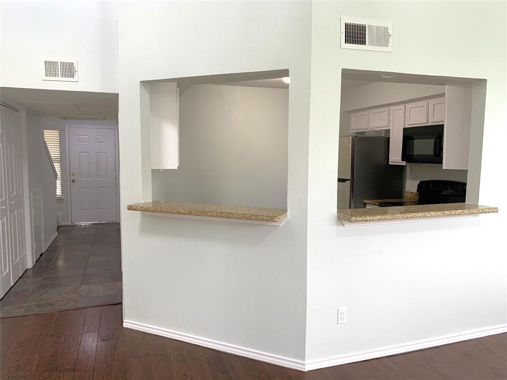 9601 Forest Lane, Unit 1024 Dallas, TX 75243 - Photo 8 of 28 a view of a hallway with wooden floor