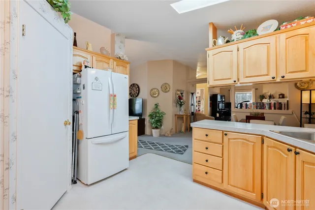 a kitchen with stainless steel appliances a refrigerator a sink a cabinets and a window