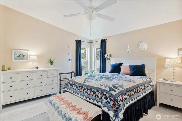 a bedroom with a bed and a dresser in it