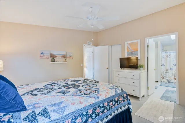 a bedroom with a bed and flat screen tv