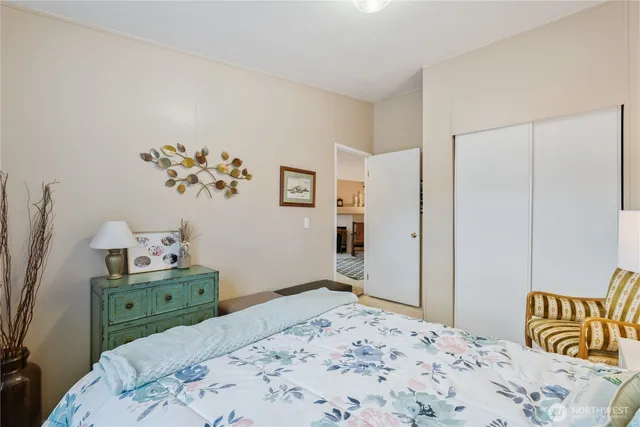 a bedroom with a bed and a dresser in it