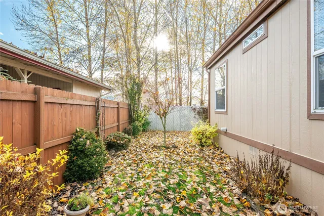 a backyard of a house with flower plants