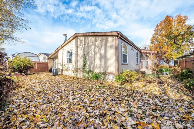 a view of a house with a large window and potted plants