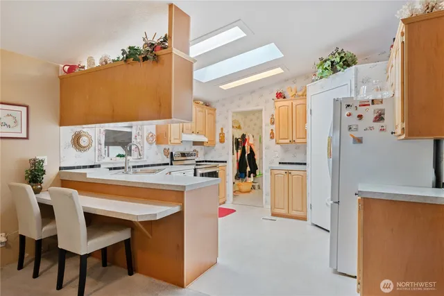 a kitchen with a refrigerator and a stove