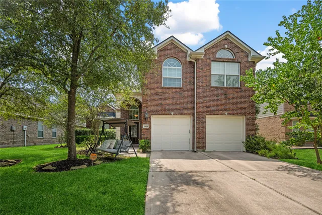 a front view of a house with a garden and yard