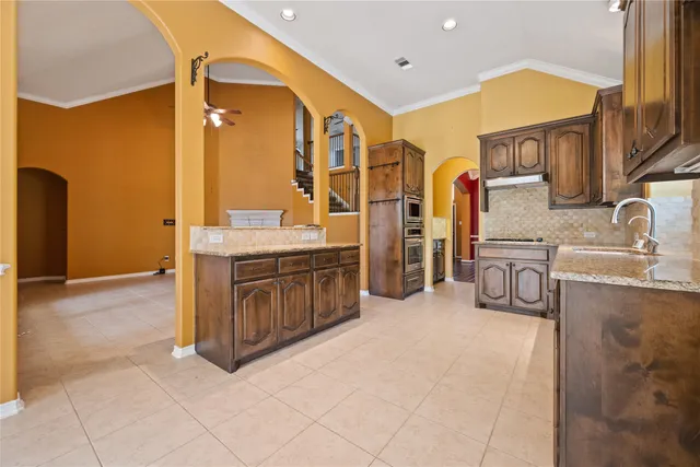 a spacious bathroom with a double vanity sink a mirror and a bathtub