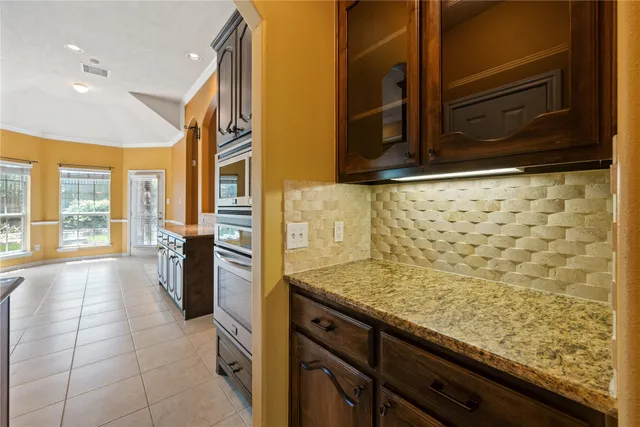 a kitchen with granite countertop sink and cabinets