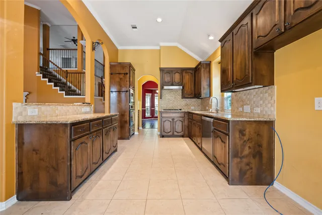 a kitchen with stainless steel appliances granite countertop a stove and a sink