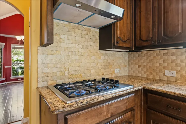 a stove top oven sitting inside of a kitchen