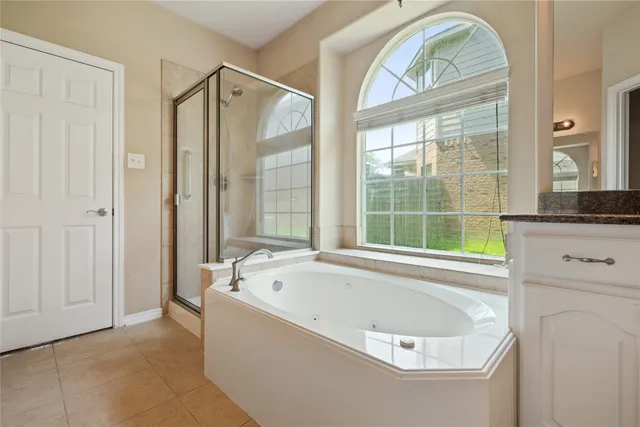 a bathroom with a tub and a window